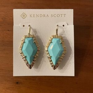 Kendra Scott dangly earrings.